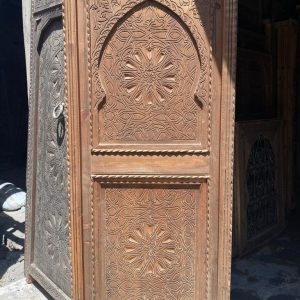 Moroccan-style handcrafted wooden door with arabesque carvings