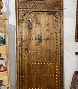 Moroccan-style handcrafted wooden door with arabesque carvings