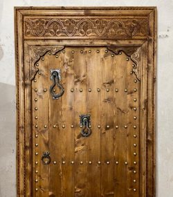 Moroccan-style handcrafted wooden door with arabesque carvings