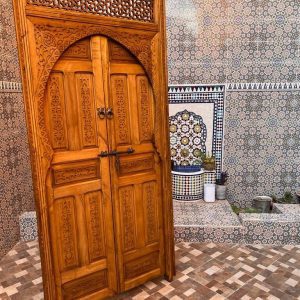 Moroccan-style handcrafted wooden door with arabesque carvings