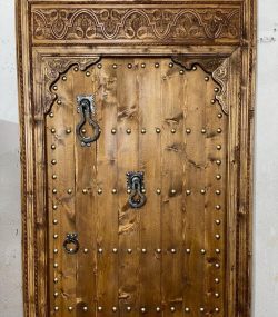 Moroccan-style handcrafted wooden door with arabesque carvings