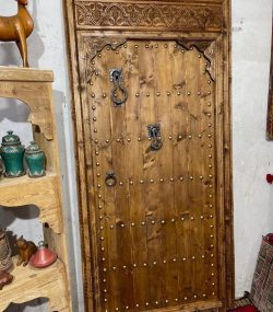 Moroccan-style handcrafted wooden door with arabesque carvings