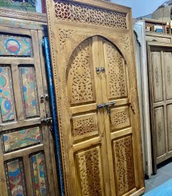 Moroccan-style handcrafted wooden door with arabesque carvings