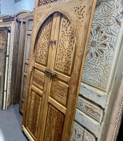 Moroccan-style handcrafted wooden door with arabesque carvings