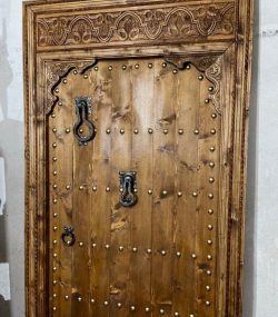 Moroccan-style handcrafted wooden door with arabesque carvings
