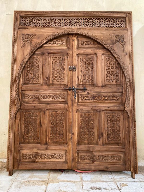 Moroccan-style handcrafted wooden door with carvings