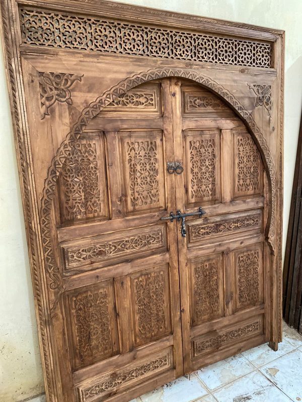 Moroccan-style handcrafted wooden door with carvings