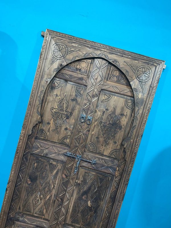 Moroccan-style handcrafted wooden door with carvings