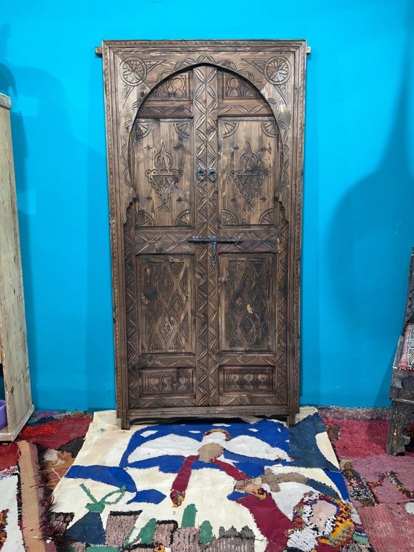 Moroccan-style handcrafted wooden door with carvings