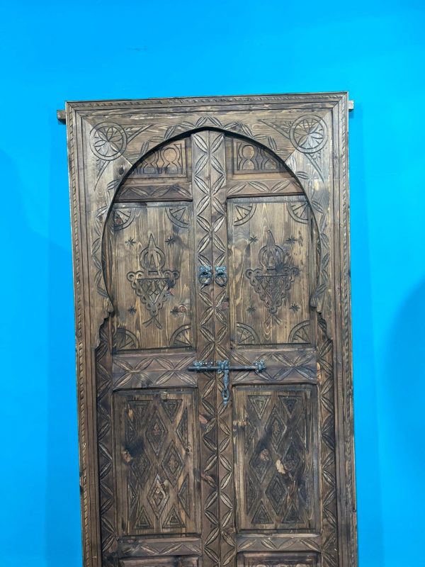 Moroccan-style handcrafted wooden door with carvings