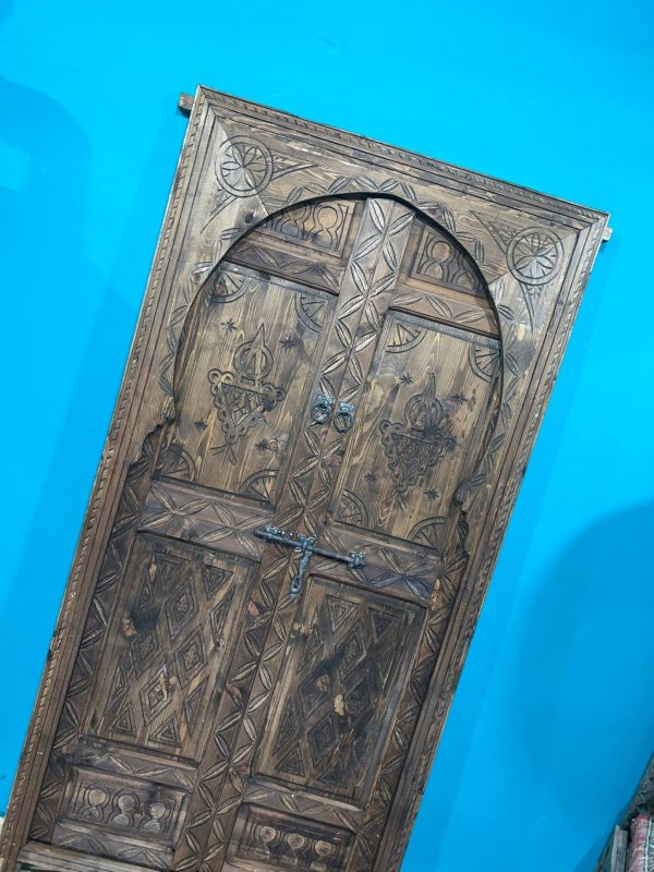 Moroccan-style handcrafted wooden door with carvings