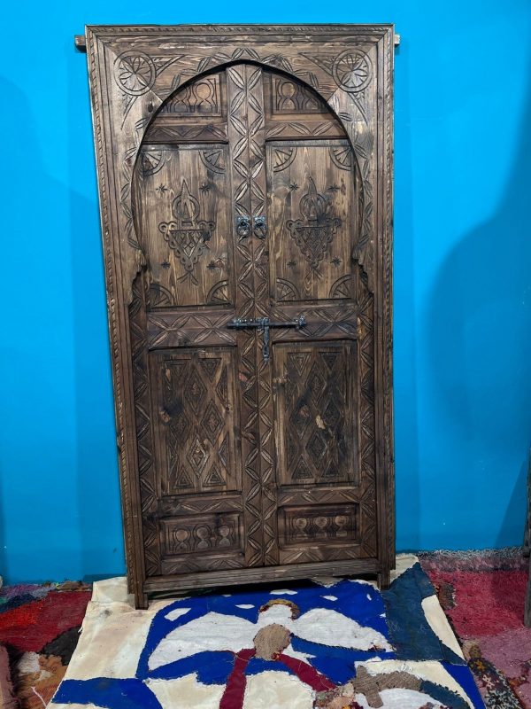 Moroccan-style handcrafted wooden door with carvings