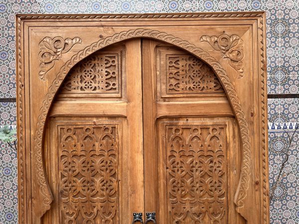 Moroccan-style handcrafted wooden door with carvings