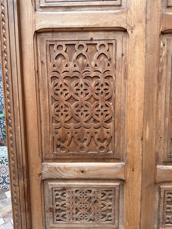 Moroccan-style handcrafted wooden door with carvings
