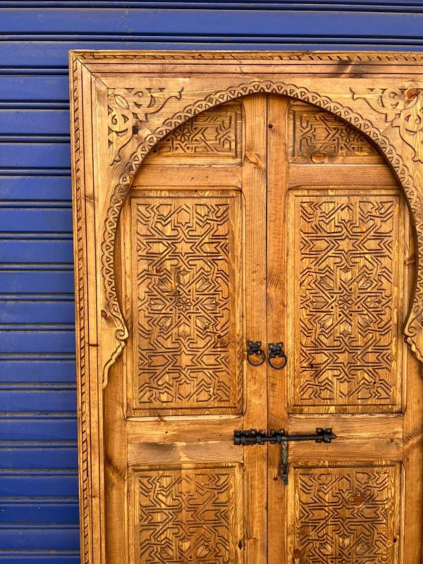 Moroccan-style handcrafted wooden door with carvings