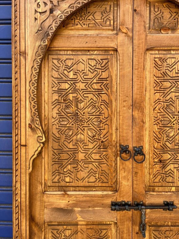 Moroccan-style handcrafted wooden door with carvings
