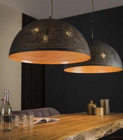carved copper Elegant Moroccan pendant light with detailed brass carvings and a soft glow.