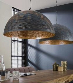 carved copper Elegant Moroccan pendant light with detailed brass carvings and a soft glow.